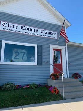The American flag flies at the Clare County Cleaver newspaper office on Main Street in Harrison, Michigan.